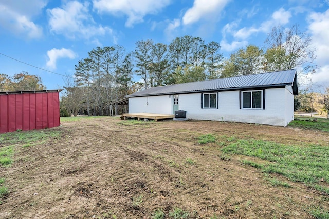 10 Grinnell Dr, Lawrenceburg, TN 38464 - back of property with metal roof, central air condition unit, a wooden deck, brick siding, and a yard
