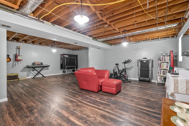finished below grade area featuring baseboards and wood finished floors