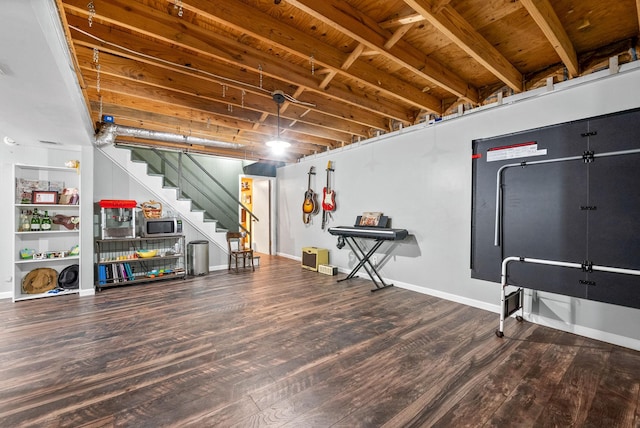 finished basement featuring wood finished floors, stairs, and baseboards