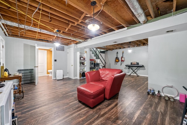 finished basement featuring wood finished floors, stairs, and baseboards