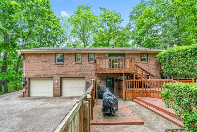 view of front facade with driveway, stairs, a deck, a garage, and brick siding