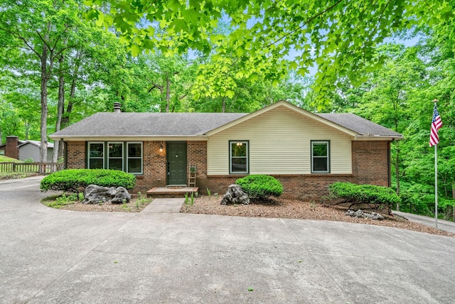 single story home with brick siding and a shingled roof