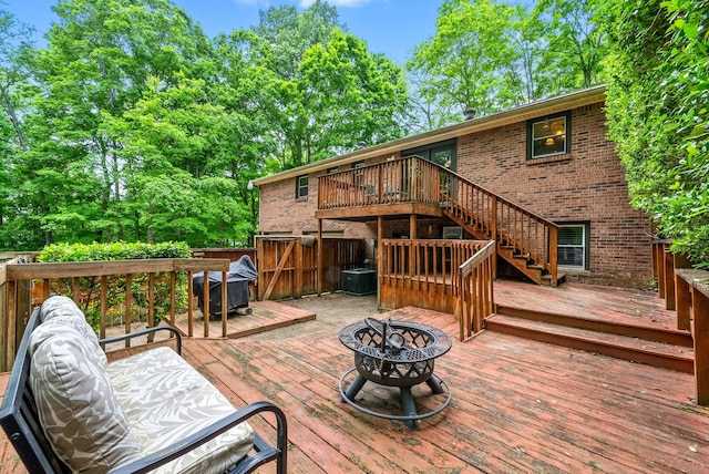 deck featuring a fire pit, stairs, and cooling unit