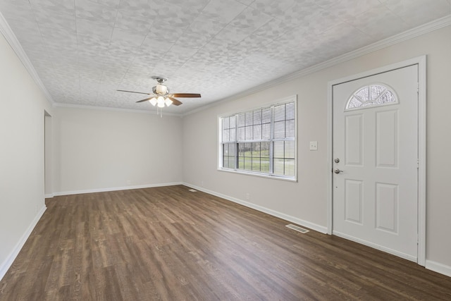 foyer with dark wood-style flooring, ceiling fan, ornamental molding, and baseboards