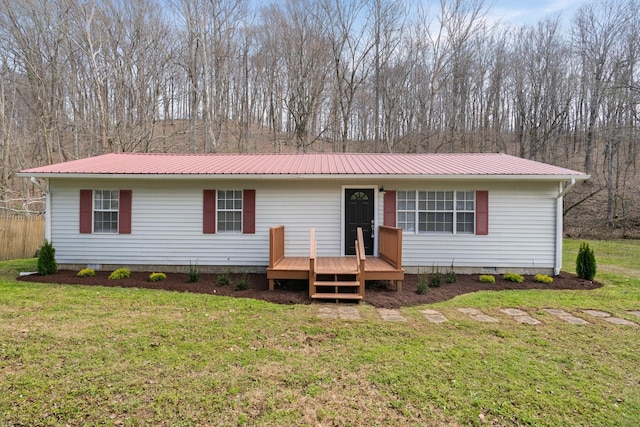 view of front of home featuring a deck, crawl space, metal roof, and a front lawn