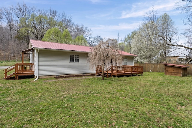 rear view of house featuring a deck, metal roof, and crawl space