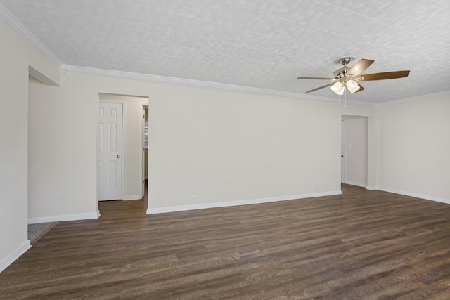 spare room featuring ceiling fan, dark wood-type flooring, crown molding, and baseboards
