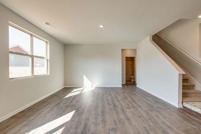 4017 Roane Dr, White House, TN 37188 - unfurnished living room with stairs, wood finished floors, baseboards, and recessed lighting
