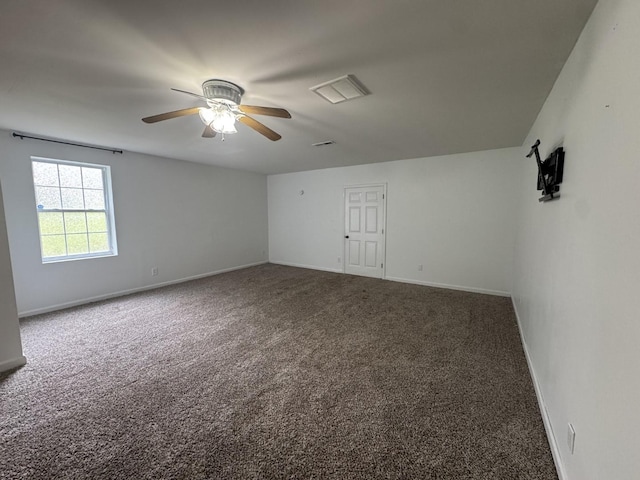 carpeted empty room with a ceiling fan and baseboards