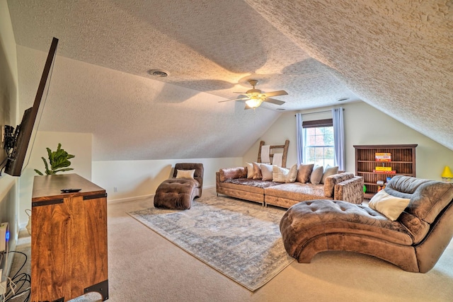 carpeted living room with a textured ceiling, lofted ceiling, and a ceiling fan