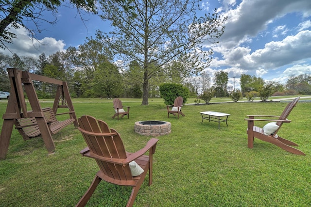 view of green lawn with a fire pit