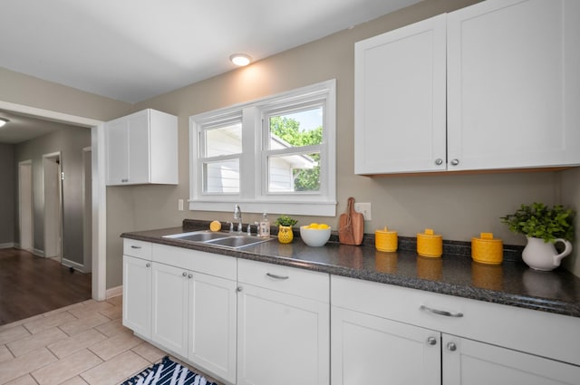 407 High St, Dickson, TN 37055 - kitchen featuring a sink, white cabinetry, dark countertops, and baseboards