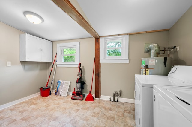 407 High St, Dickson, TN 37055 - clothes washing area featuring water heater, separate washer and dryer, baseboards, and cabinet space