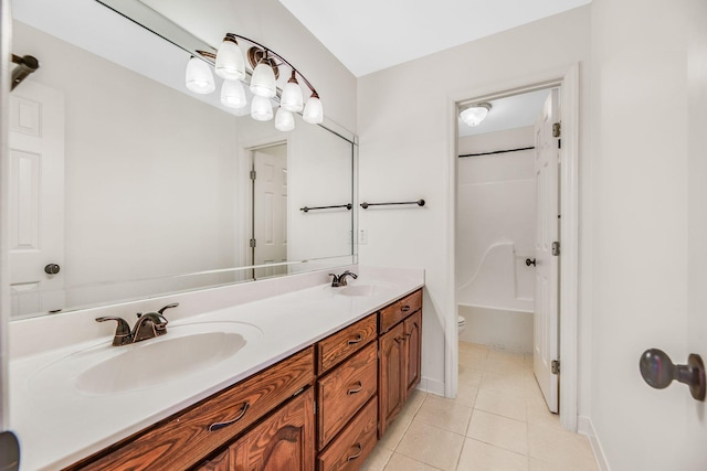 bathroom featuring tile patterned flooring, double vanity, toilet, and shower / bathtub combination