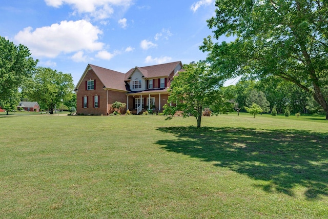 view of front of home featuring a front yard and brick siding