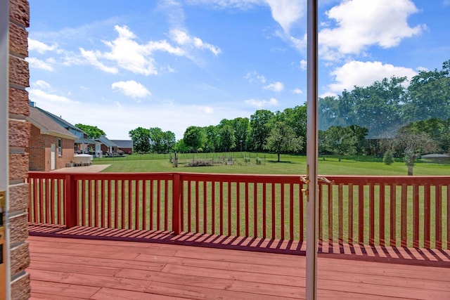wooden terrace featuring a yard