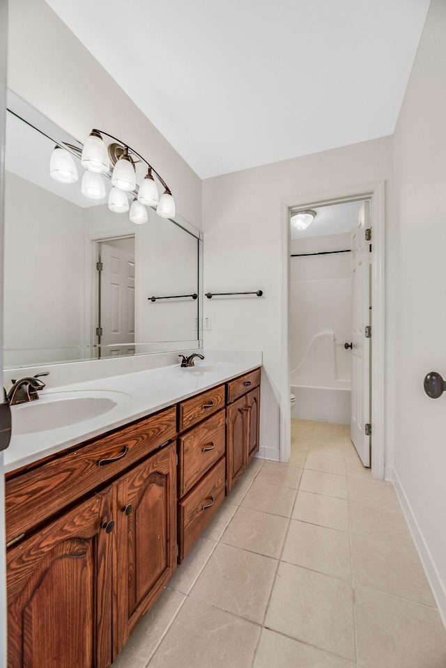 bathroom featuring tile patterned flooring, double vanity, baseboards, a bath, and a shower