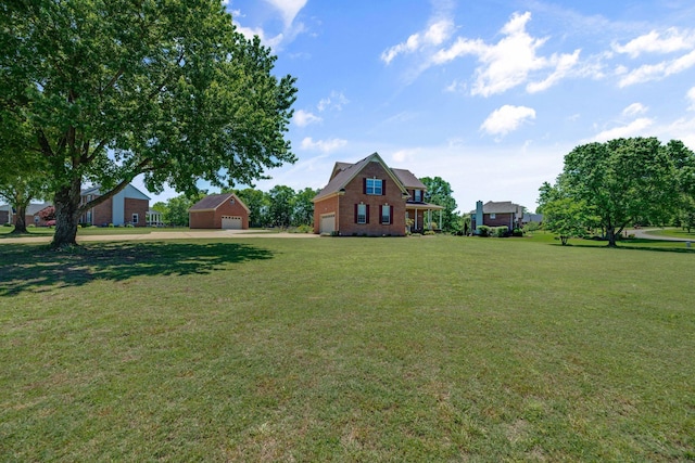 view of grassy yard with a garage