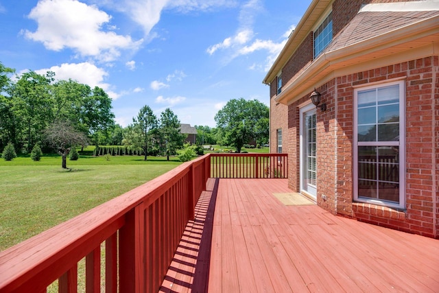 wooden terrace featuring a yard