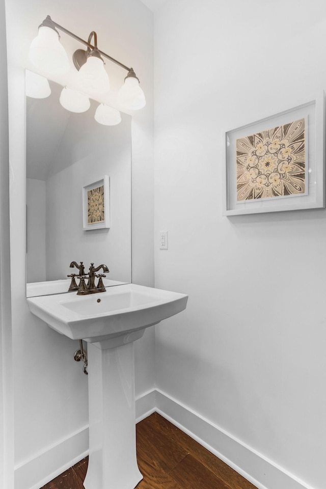 bathroom with baseboards and wood finished floors