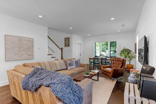 living area with wood finished floors, stairway, and recessed lighting
