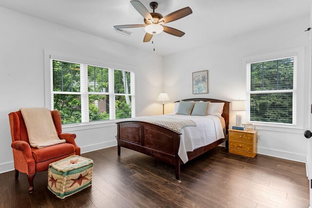 bedroom featuring baseboards, dark wood finished floors, and ceiling fan