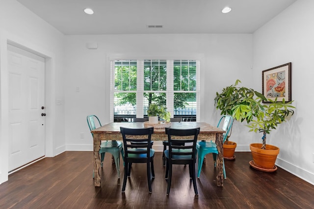 dining room featuring wood finished floors, baseboards, and recessed lighting