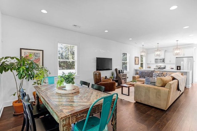 dining space with plenty of natural light, dark wood-style floors, and recessed lighting