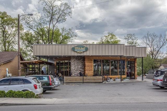 view of building exterior with uncovered parking