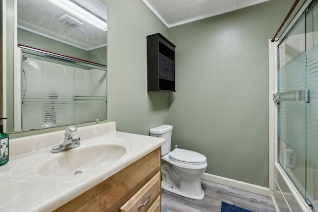 full bath featuring wood finished floors, vanity, toilet, and baseboards