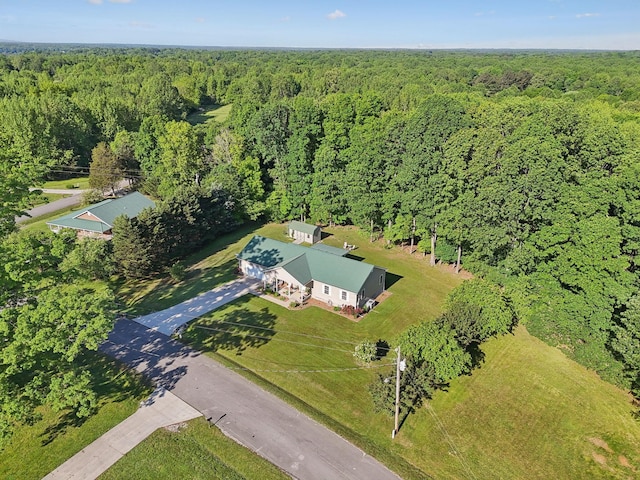 view of subject property featuring a heavily wooded area