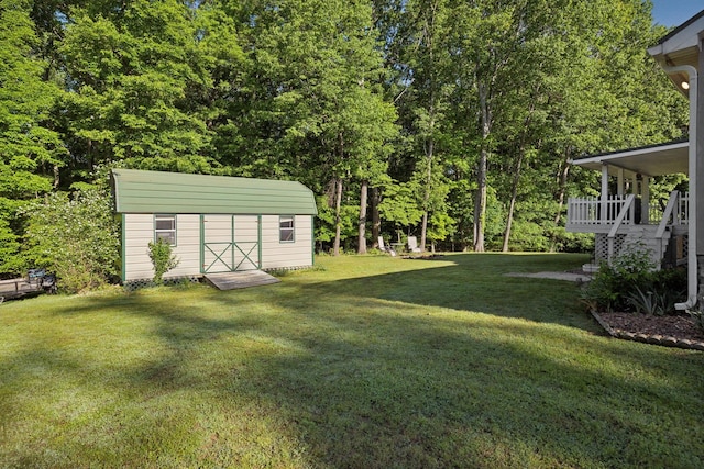 view of grassy yard with a storage unit and an outdoor structure