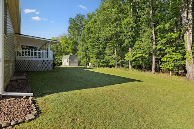view of grassy yard featuring a storage unit and an outdoor structure