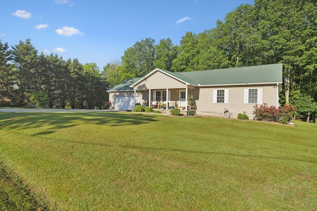 ranch-style house featuring an attached garage, a porch, a front lawn, and metal roof