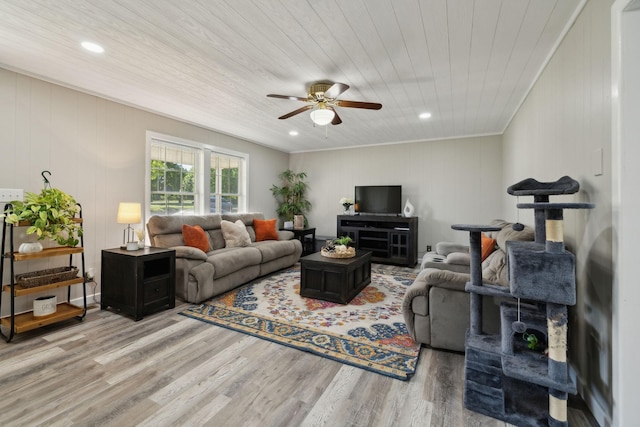 living area featuring a ceiling fan, light wood-style flooring, wooden ceiling, ornamental molding, and recessed lighting