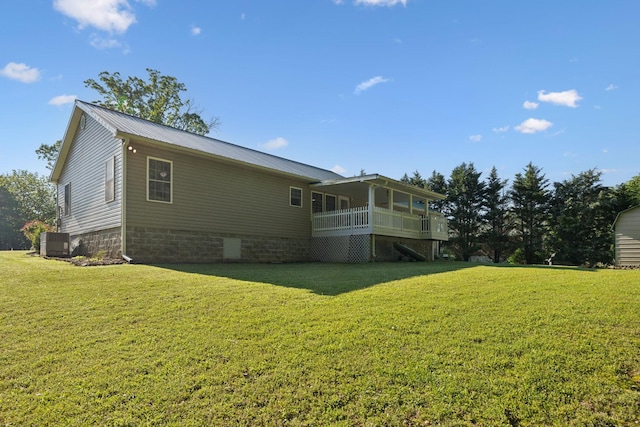 rear view of property with central AC unit, a lawn, and stairs