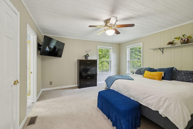 carpeted bedroom featuring baseboards, wooden ceiling, ceiling fan, and wood walls