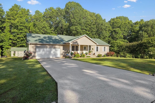 single story home with covered porch, an attached garage, driveway, and a front yard