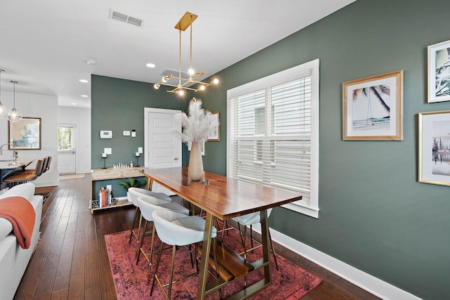 dining space with baseboards, a chandelier, recessed lighting, and dark wood finished floors