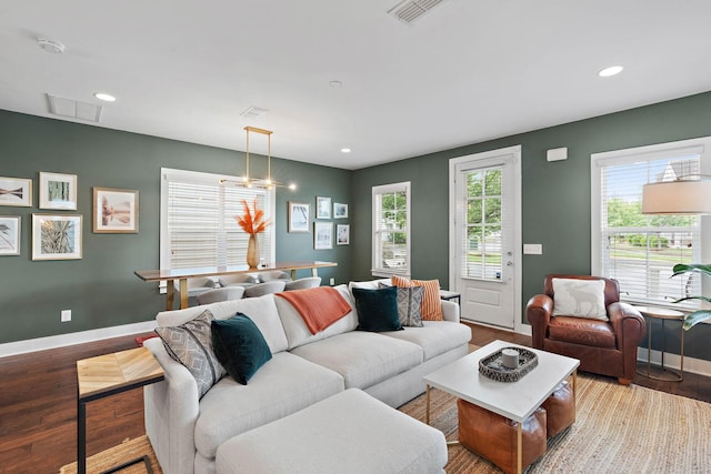 living room with baseboards, wood finished floors, and recessed lighting