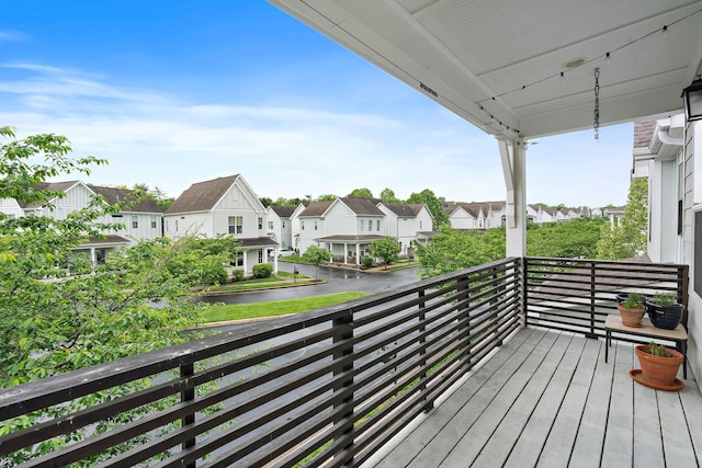 balcony featuring a residential view and a water view