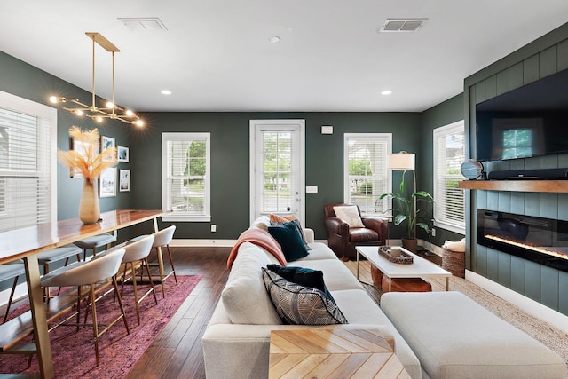 living area with dark wood-style floors, healthy amount of natural light, baseboards, a fireplace, and recessed lighting