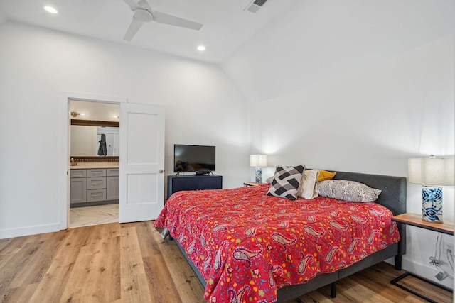 bedroom with vaulted ceiling, light wood-style flooring, recessed lighting, connected bathroom, and a ceiling fan