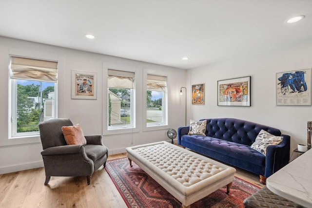 living area with plenty of natural light, light wood-style floors, recessed lighting, and baseboards