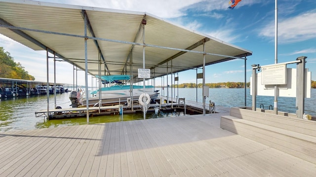 dock area with boat lift and a water view