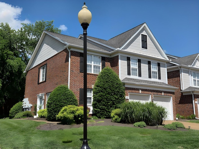 view of front of house with brick siding, a front lawn, a garage, and a shingled roof