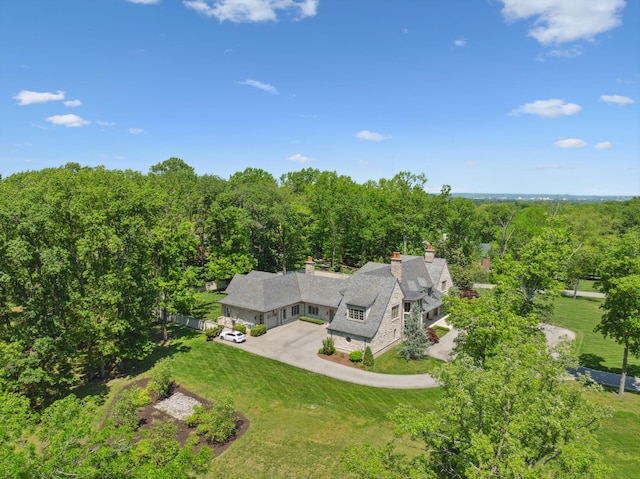 aerial view of property and surrounding area featuring a forest