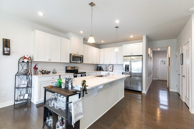 kitchen featuring stainless steel appliances, dark wood-style flooring, baseboards, light countertops, and white cabinets