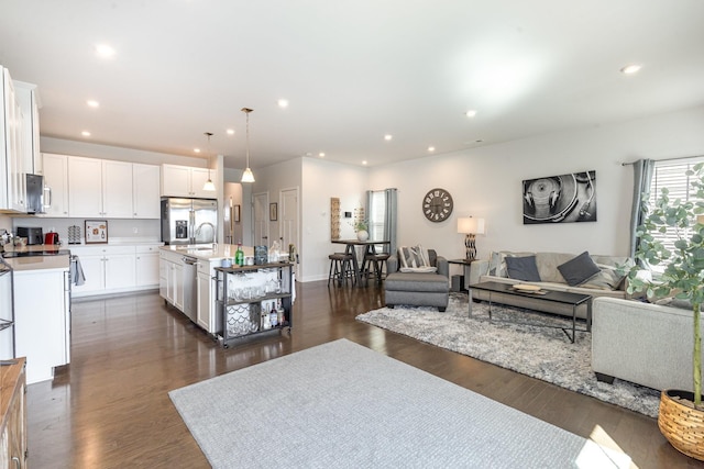 living area with dark wood finished floors and recessed lighting