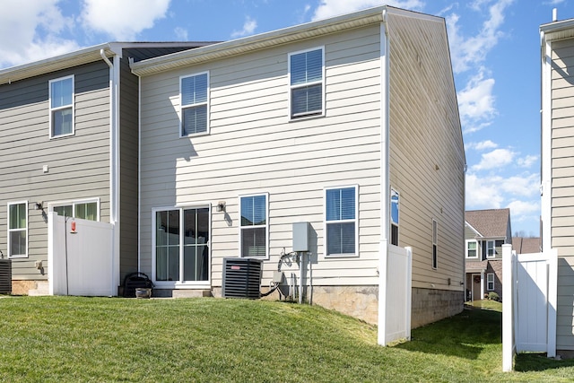 rear view of property with central AC unit